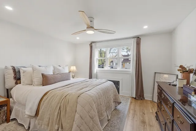 a bedroom with a large bed and a window