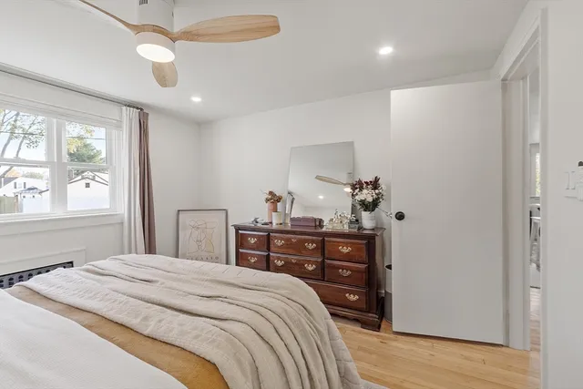 a bedroom with a bed and wooden floor