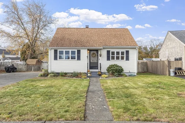 a backyard of a house with table and chairs