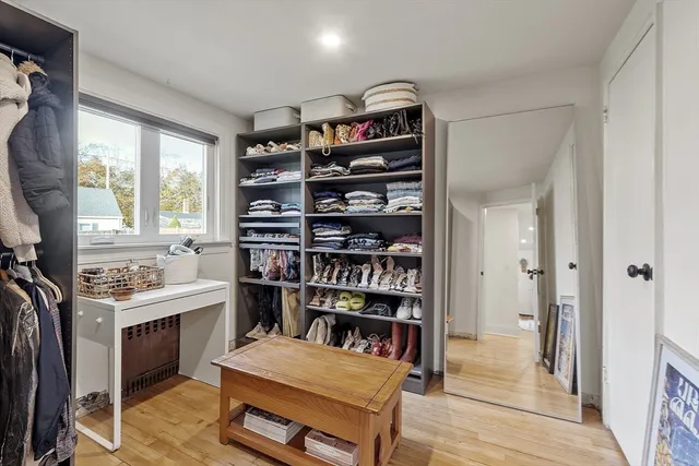 a room with furniture a window and bookshelf