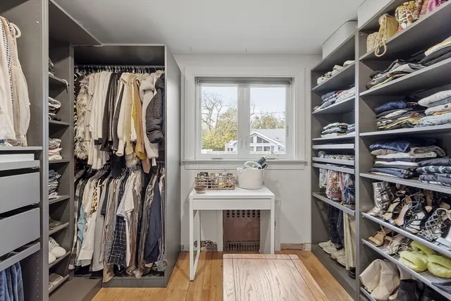 a view of walk in closet with clothes and shoes