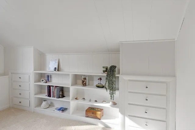 a kitchen with white cabinets and white appliances