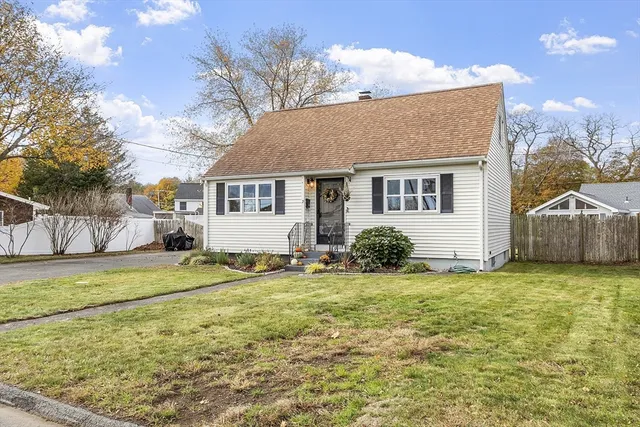 a view of a house with a yard and garage
