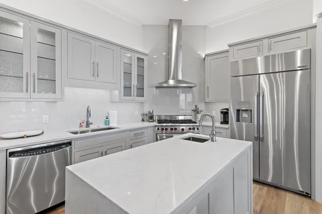a kitchen with stainless steel appliances granite countertop a sink stove and refrigerator