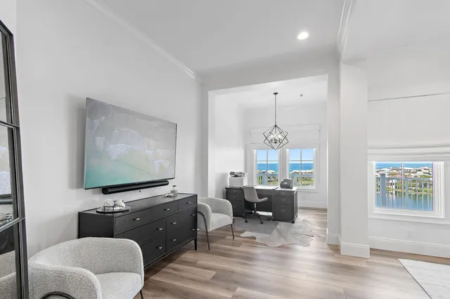 a bedroom with a bed and a flat tv screen on dresser