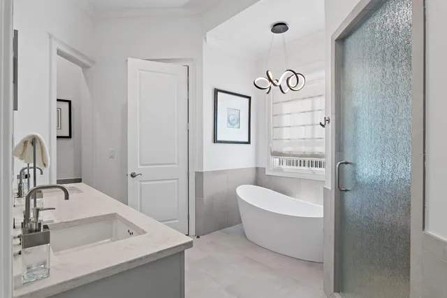 a bedroom with a bed and a flat tv screen on the dresser