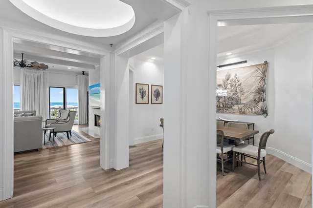 a living room with furniture a chandelier and a dining table
