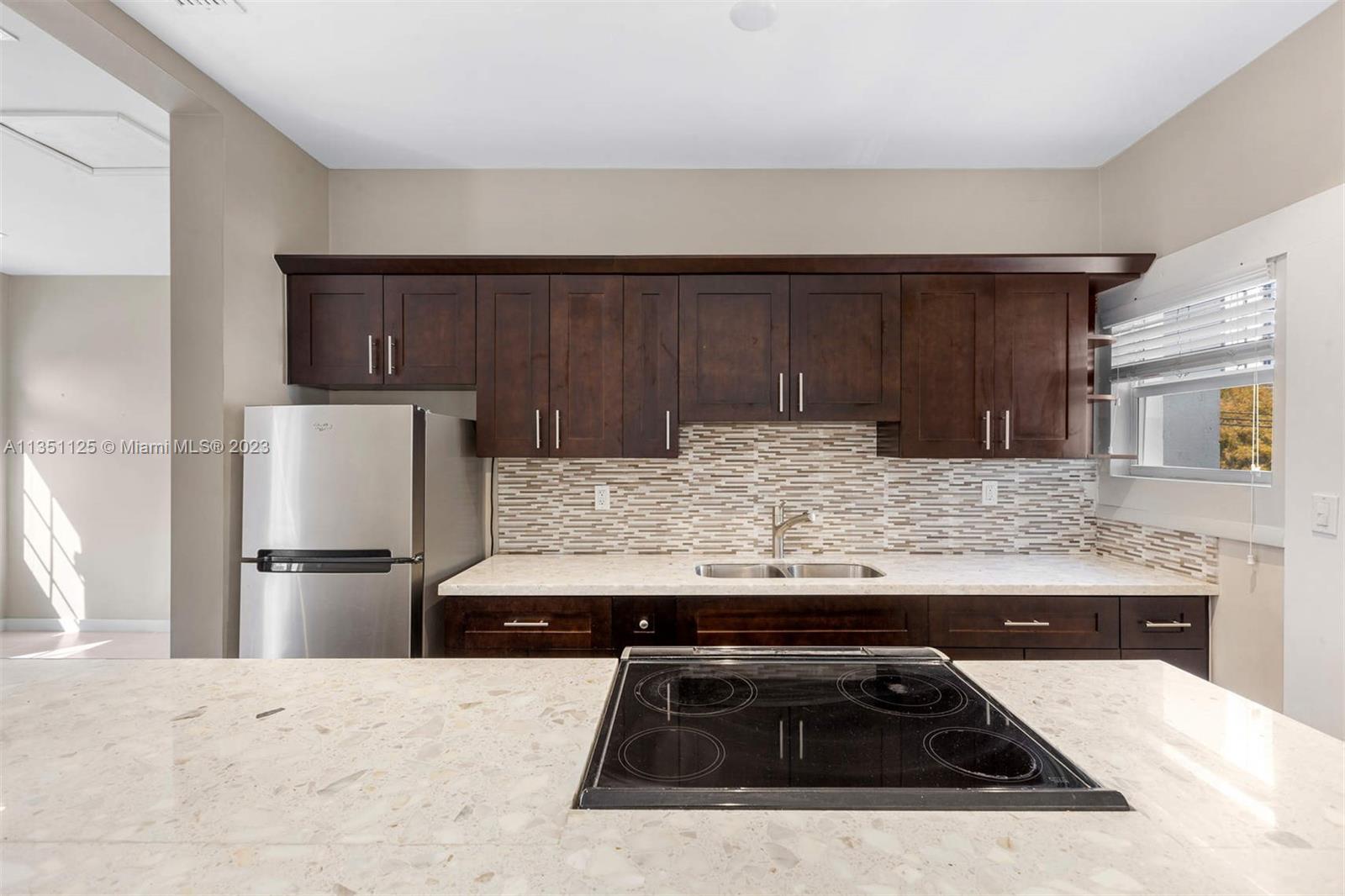 a kitchen with granite countertop a stove and a refrigerator