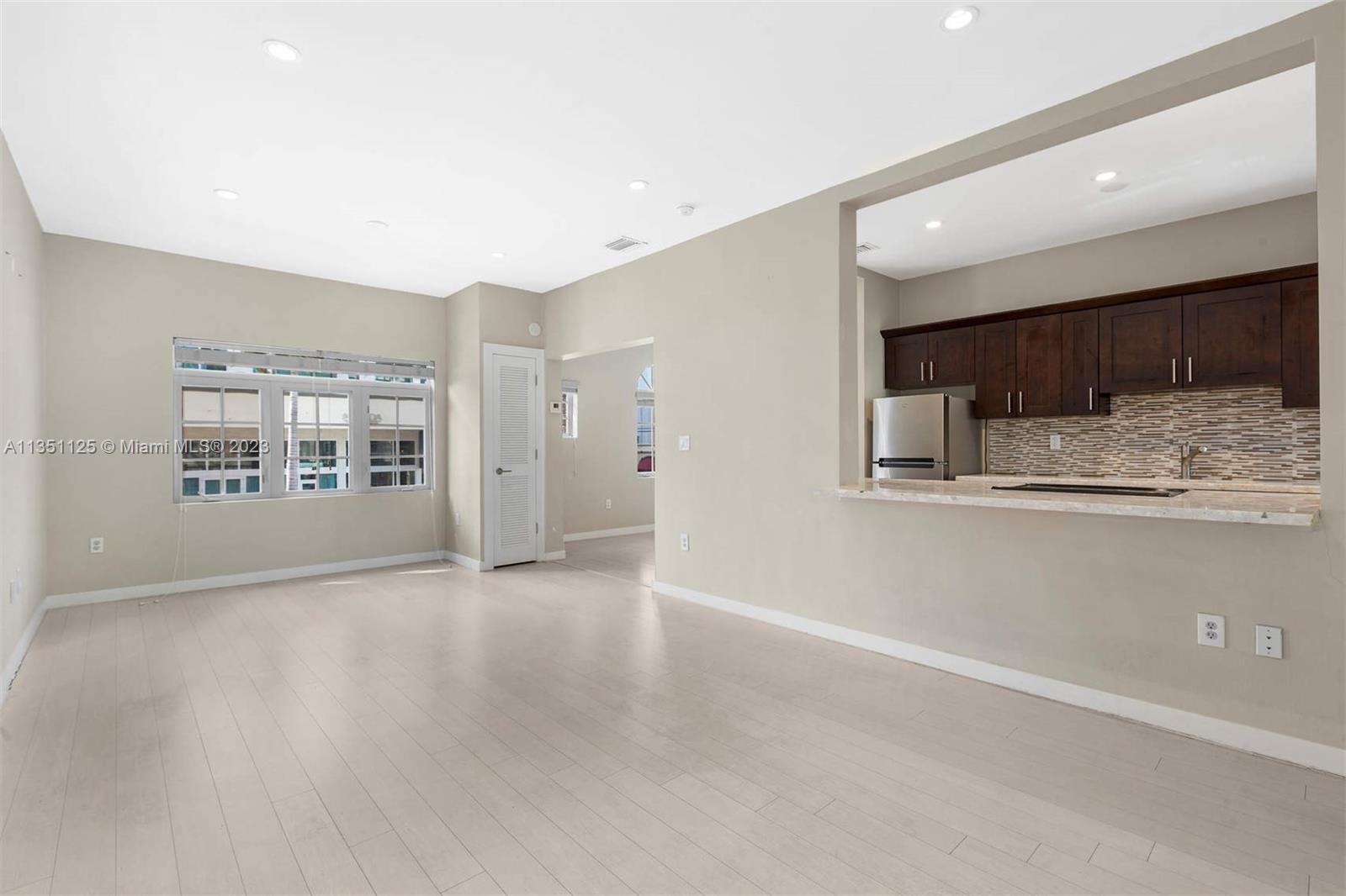 2423 Biscayne Boulevard, Unit 2 Miami, FL 33137 - Photo 2 of 14 a view of an empty room with kitchen and window