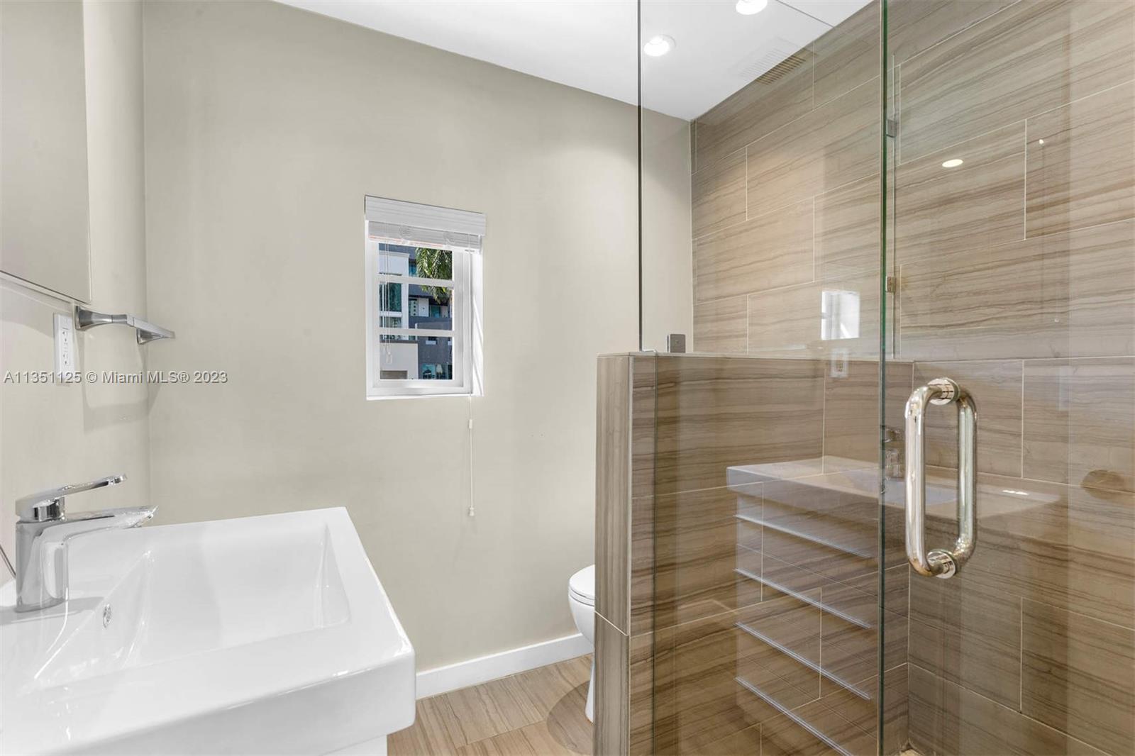 2423 Biscayne Boulevard, Unit 2 Miami, FL 33137 - Photo 7 of 14 a bathroom with a sink and a shower