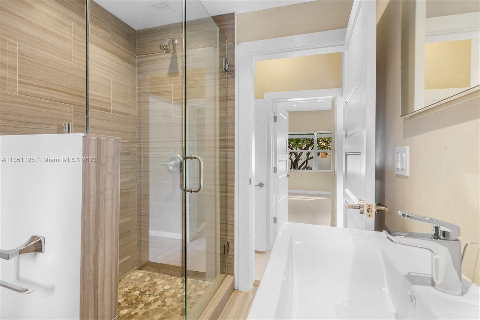 2423 Biscayne Boulevard, Unit 2 Miami, FL 33137 - Photo 8 of 14 a bathroom with a sink and shower