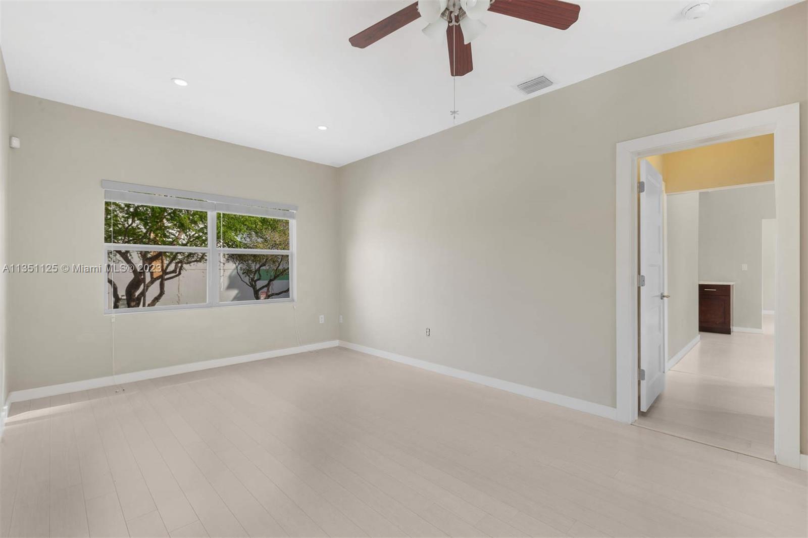 2423 Biscayne Boulevard, Unit 2 Miami, FL 33137 - Photo 9 of 14 an empty room with windows and ceiling fan
