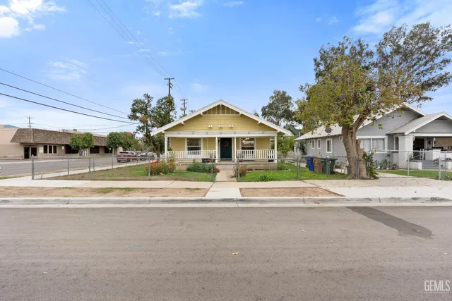 a view of pool with outdoor seating and house in the background