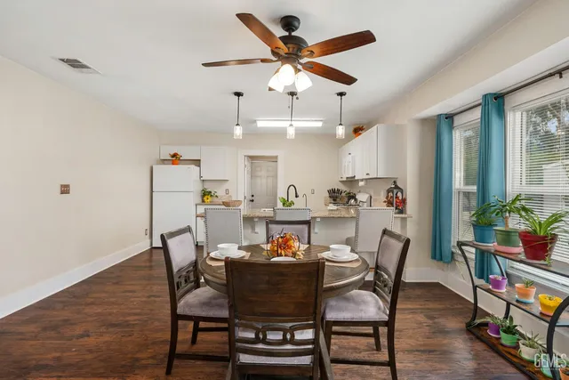 a view of a dining room with furniture and wooden floor