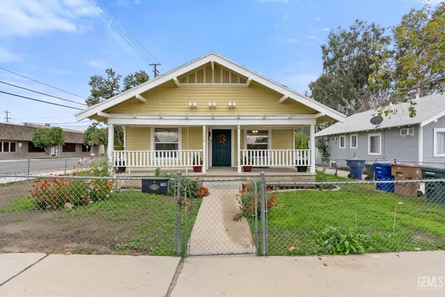 a front view of a house with a garden and patio
