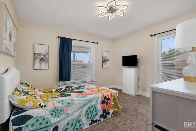 a bedroom that has a bed and a flat screen tv