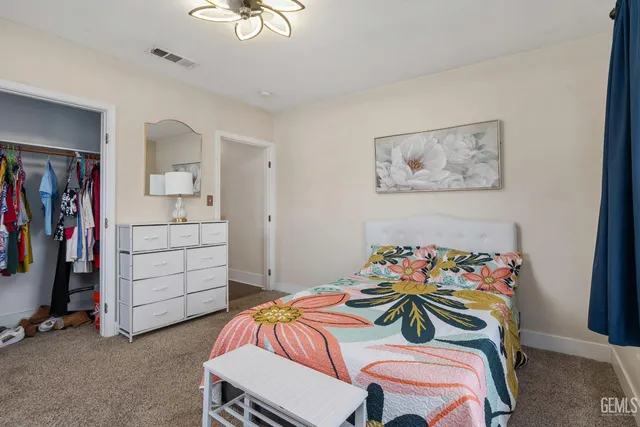 a bedroom with a bed and a cabinet