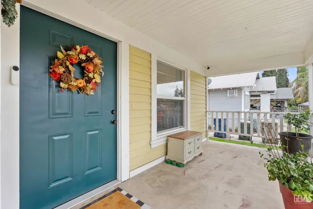an entryway with a flower pot and a potted plant