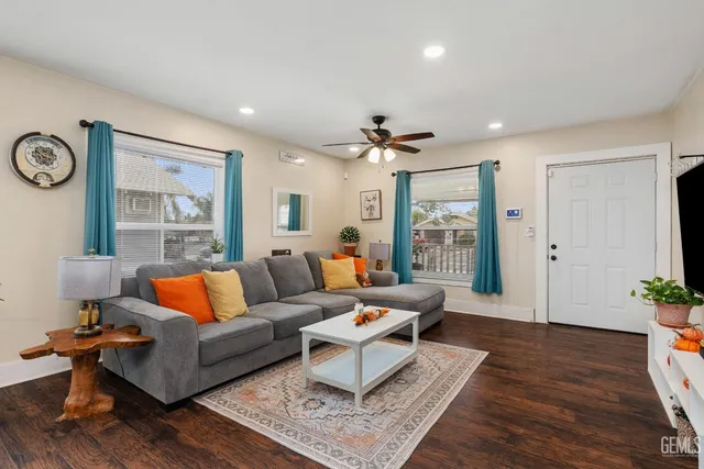 a living room with furniture and wooden floor