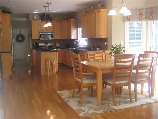 33 Pennock Road Ashland, MA 01721 - Photo 3 of 14 a kitchen with granite countertop a table chairs and a chandelier