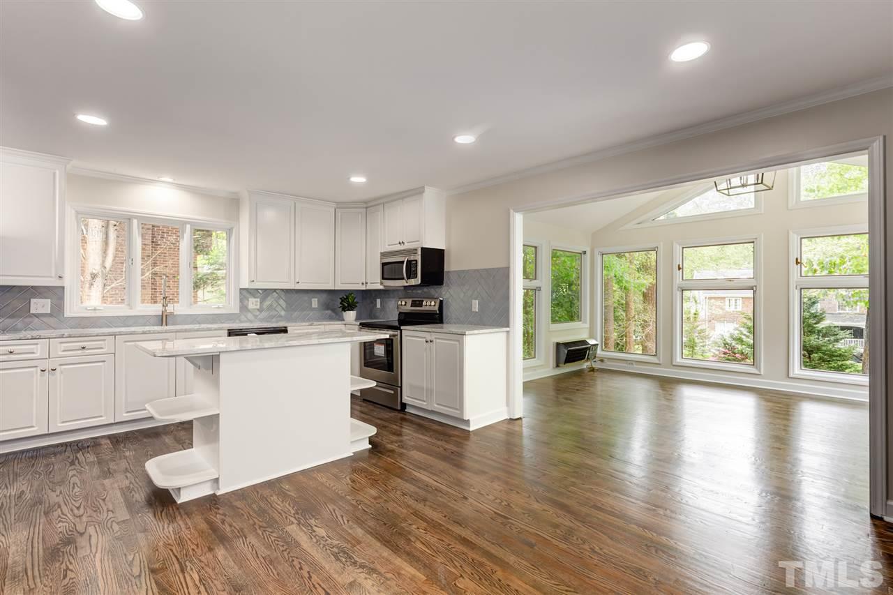 6820 Rainwater Road Raleigh, NC 27615 - Photo 13 of 22 a kitchen with a refrigerator and white cabinets