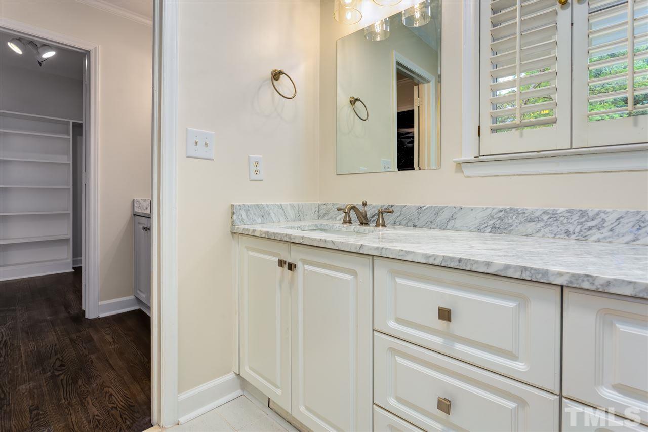 6820 Rainwater Road Raleigh, NC 27615 - Photo 18 of 22 a bathroom with a sink and a mirror
