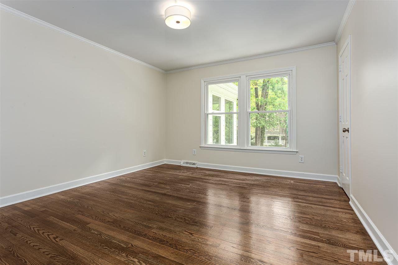6820 Rainwater Road Raleigh, NC 27615 - Photo 19 of 22 an empty room with wooden floor and windows