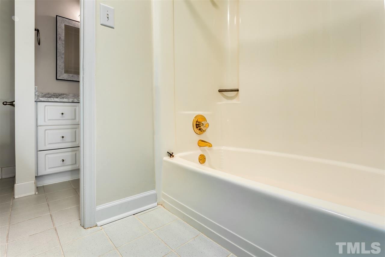6820 Rainwater Road Raleigh, NC 27615 - Photo 21 of 22 a bathroom with a bathtub and a shower