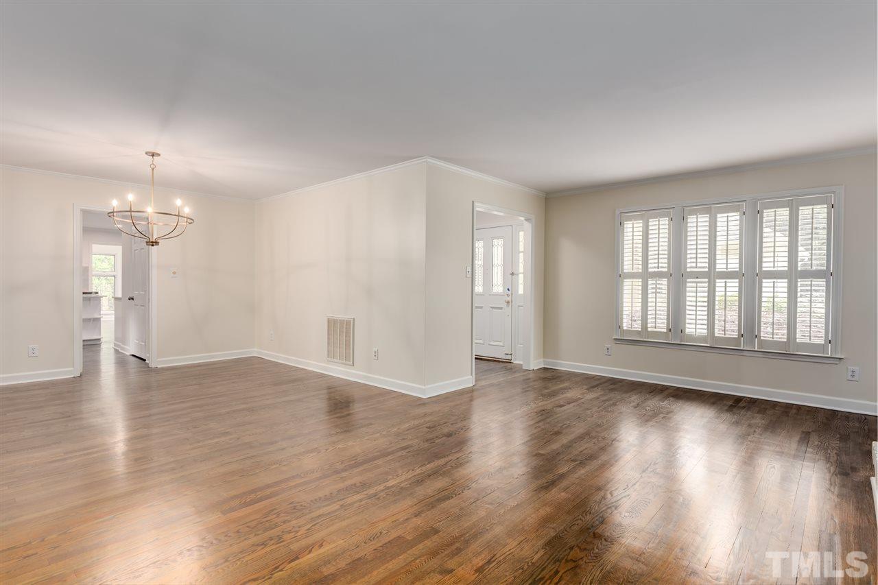 6820 Rainwater Road Raleigh, NC 27615 - Photo 9 of 22 an empty room with wooden floor and windows