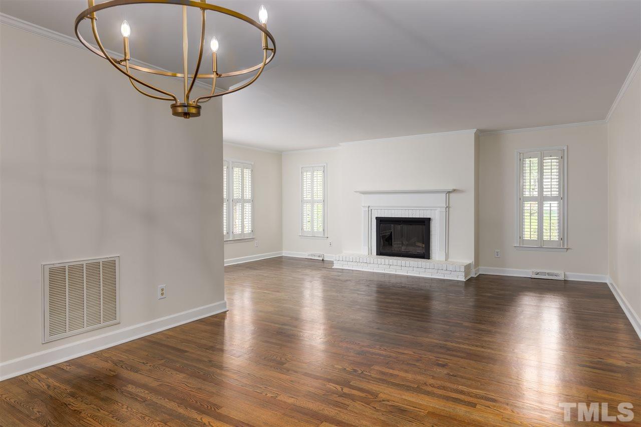 6820 Rainwater Road Raleigh, NC 27615 - Photo 10 of 22 a view of an empty room with wooden floor and a window