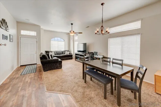 a living room with furniture a window and a chandelier
