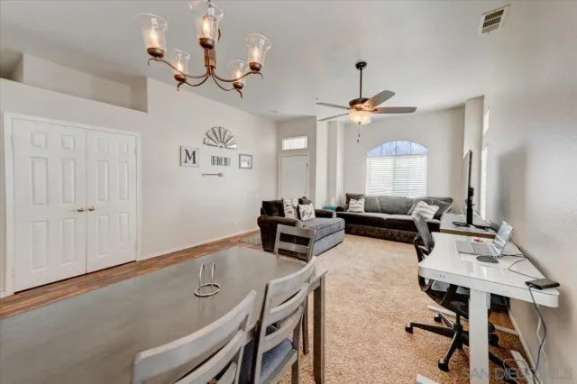 a living room with furniture a chandelier and a window