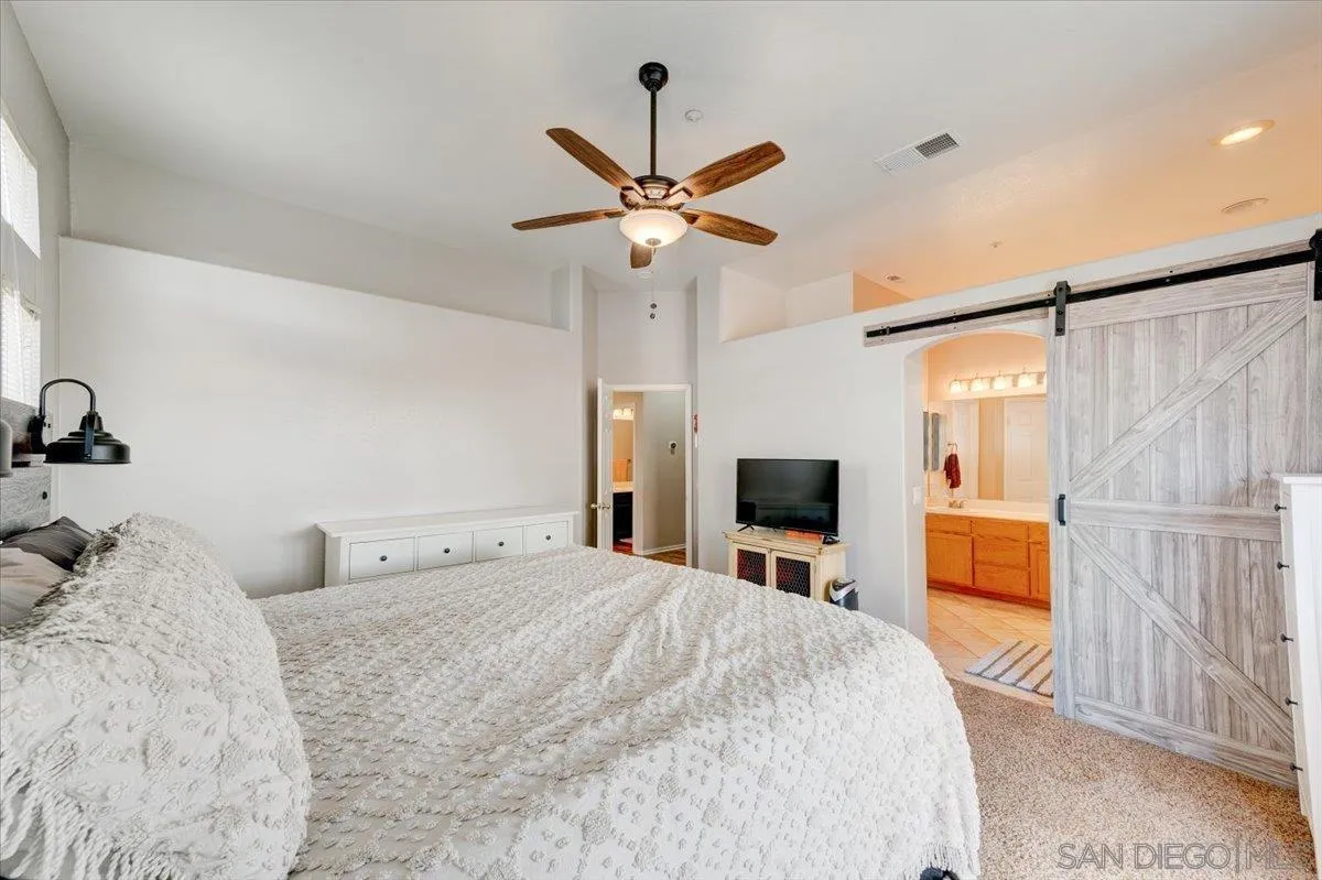 1359 H Street Ramona, CA 92065 - Photo 22 of 52 a bedroom with a bed and a chandelier