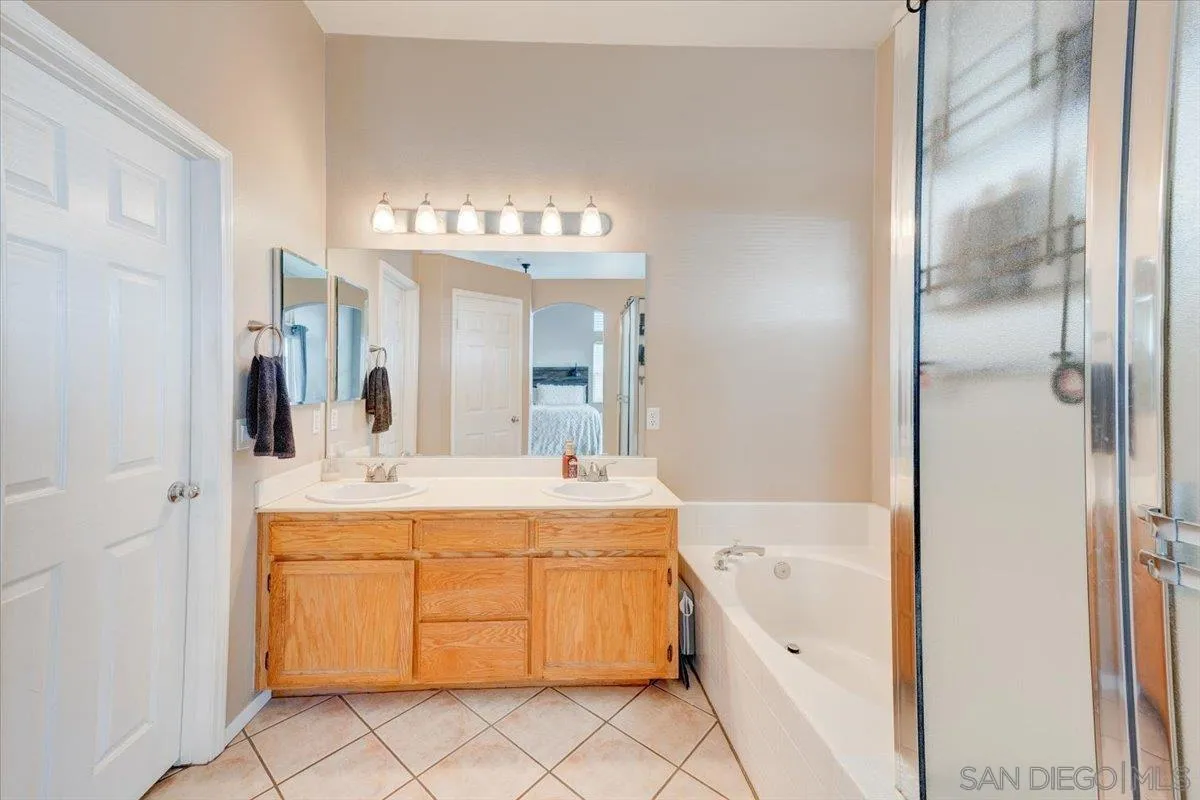 1359 H Street Ramona, CA 92065 - Photo 25 of 52 a bathroom with a tub sink and mirror