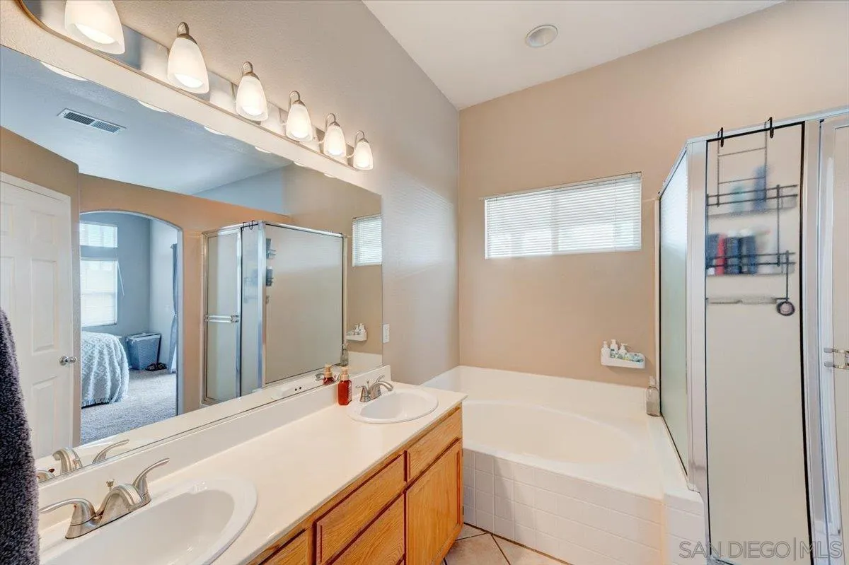 1359 H Street Ramona, CA 92065 - Photo 26 of 52 a bathroom with a tub a sink and a large mirror