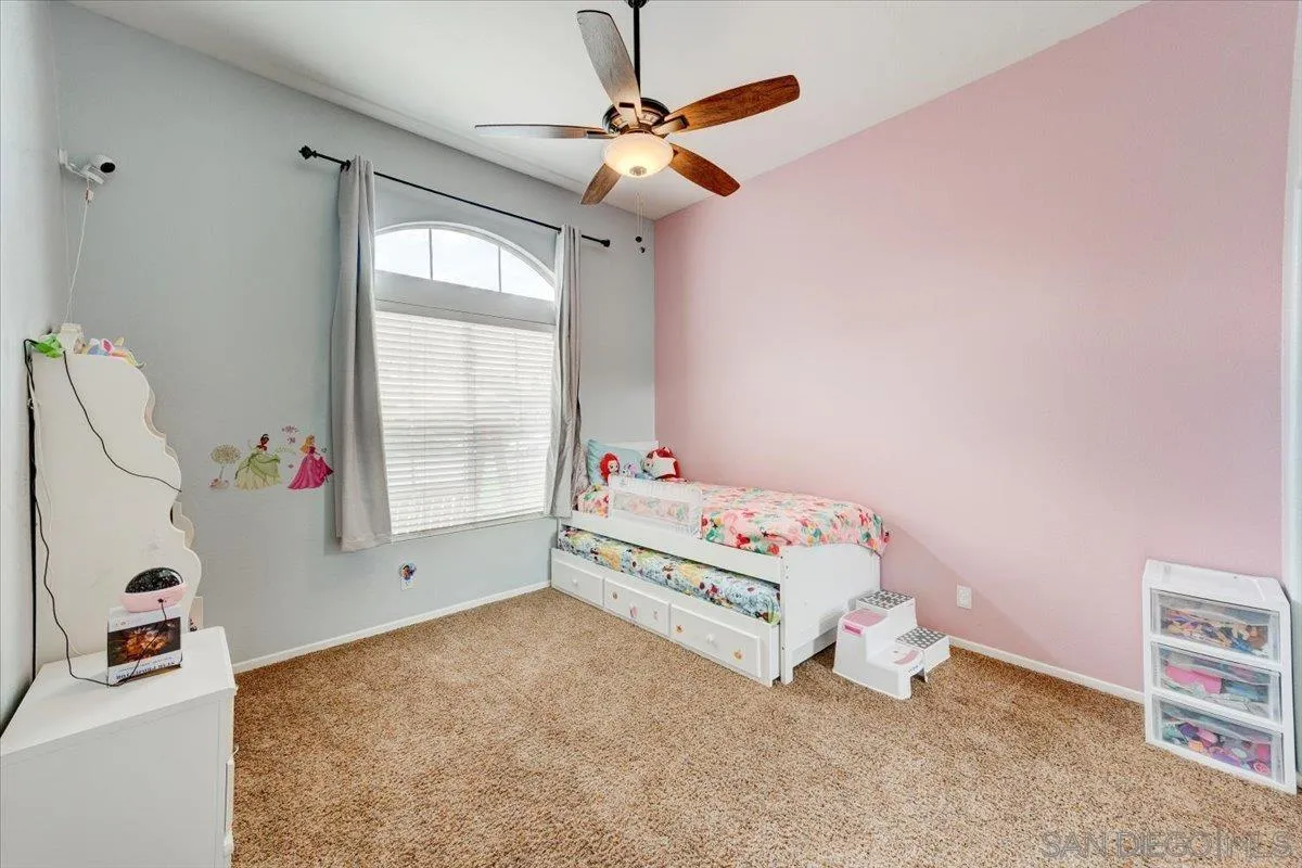 1359 H Street Ramona, CA 92065 - Photo 30 of 52 a bedroom with a bed and a chandelier