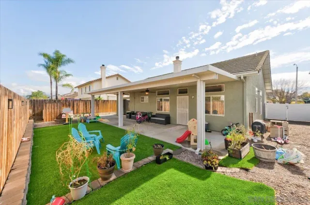 a front view of house with yard outdoor seating and patio