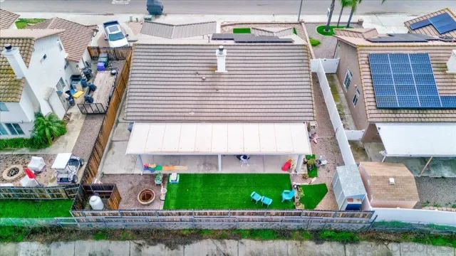 aerial view of a house with a yard and potted plants