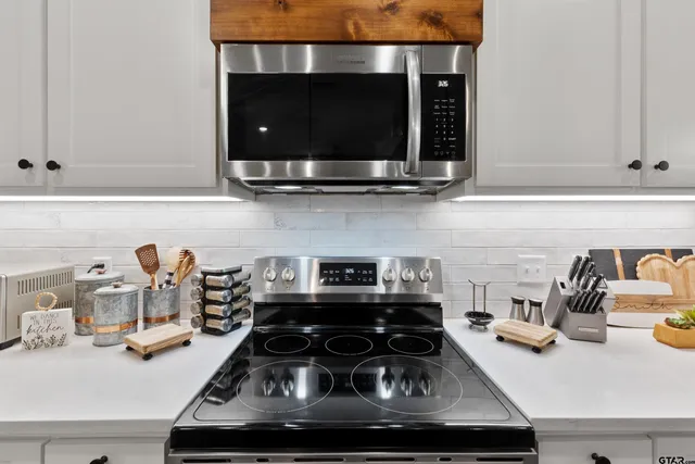 a kitchen with a stove and a microwave