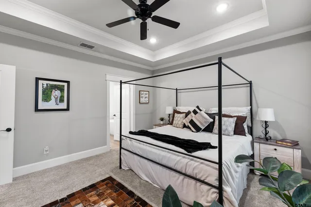 a bedroom with a bed and ceiling fan