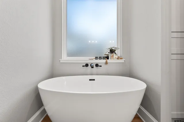 a white bath tub sitting in a bathroom
