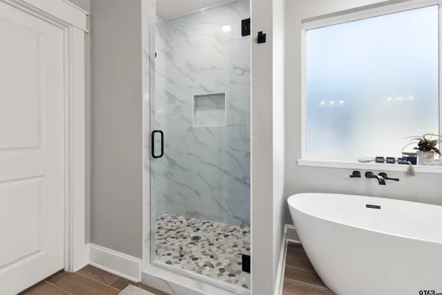 a bathroom with a bathtub and shower