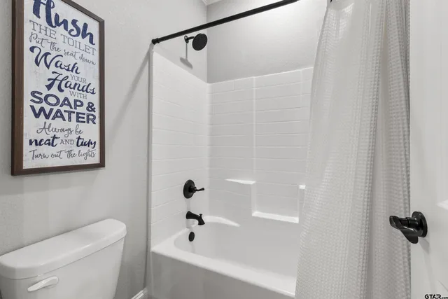 a white toilet sitting next to a bathroom sink