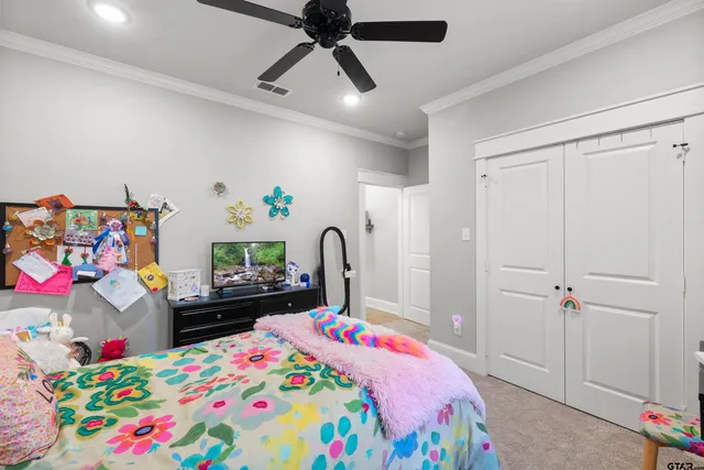 a bedroom with a bed dresser and a baby crib