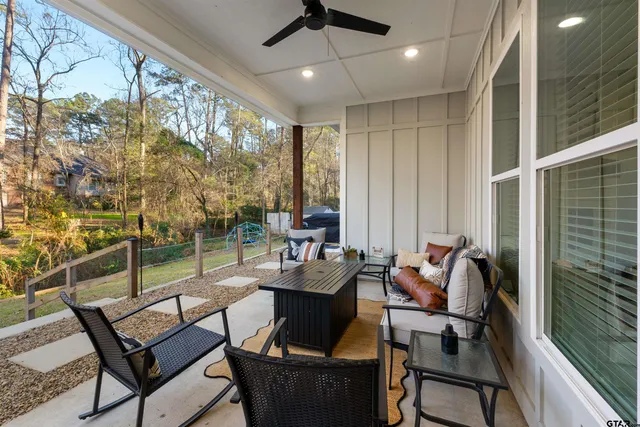 a living room with furniture and a floor to ceiling window