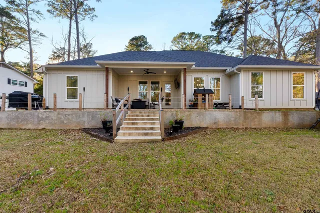a view of a house with a yard and sitting area