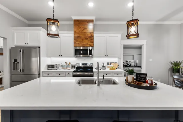 a kitchen with a sink a stove and refrigerator
