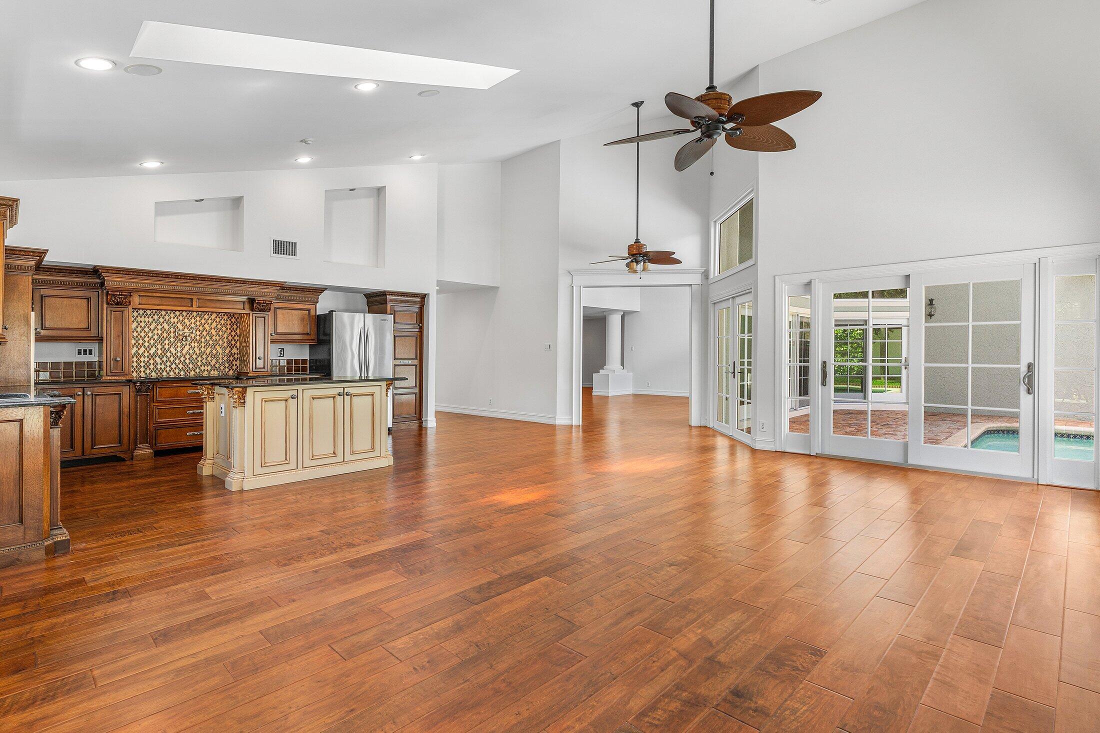 2599 Northwest 49th Street Boca Raton, FL 33434 - Photo 18 of 40 a view of empty room with wooden floor and windows