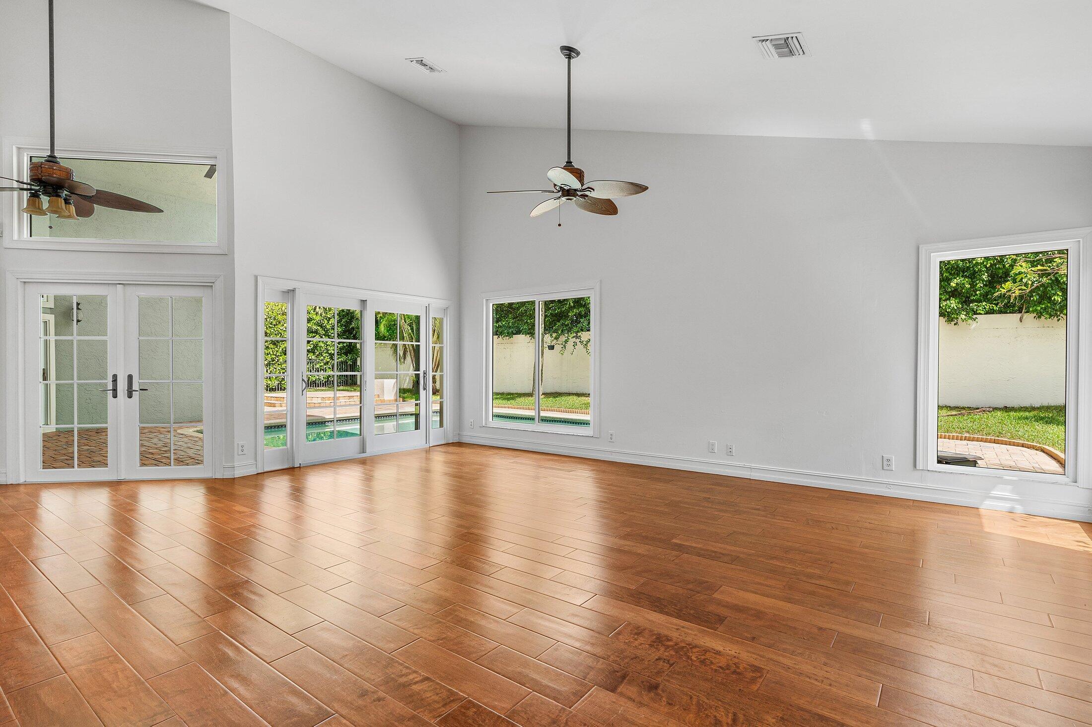 2599 Northwest 49th Street Boca Raton, FL 33434 - Photo 19 of 40 a view of an empty room with a window and wooden floor