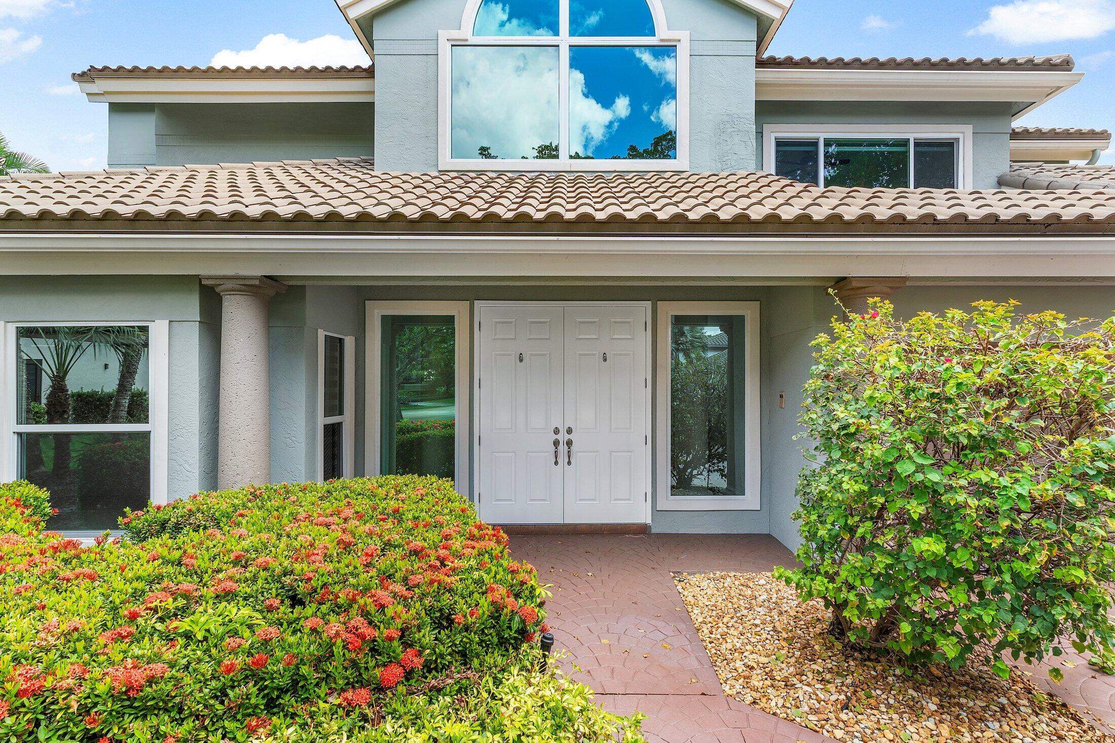2599 Northwest 49th Street Boca Raton, FL 33434 - Photo 4 of 40 a front view of a house with garden